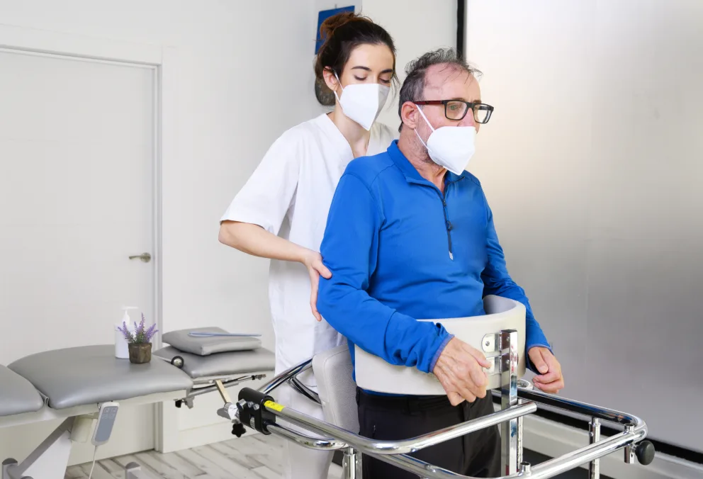 Nurse examining patient with ALS